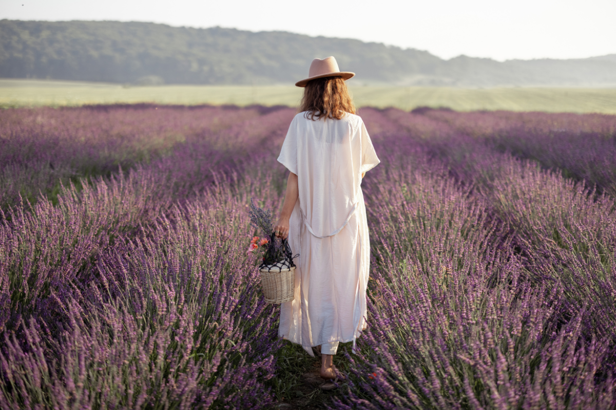 Woman walking through a lavender field wondering how long it takes for hormone replacement therapy to work